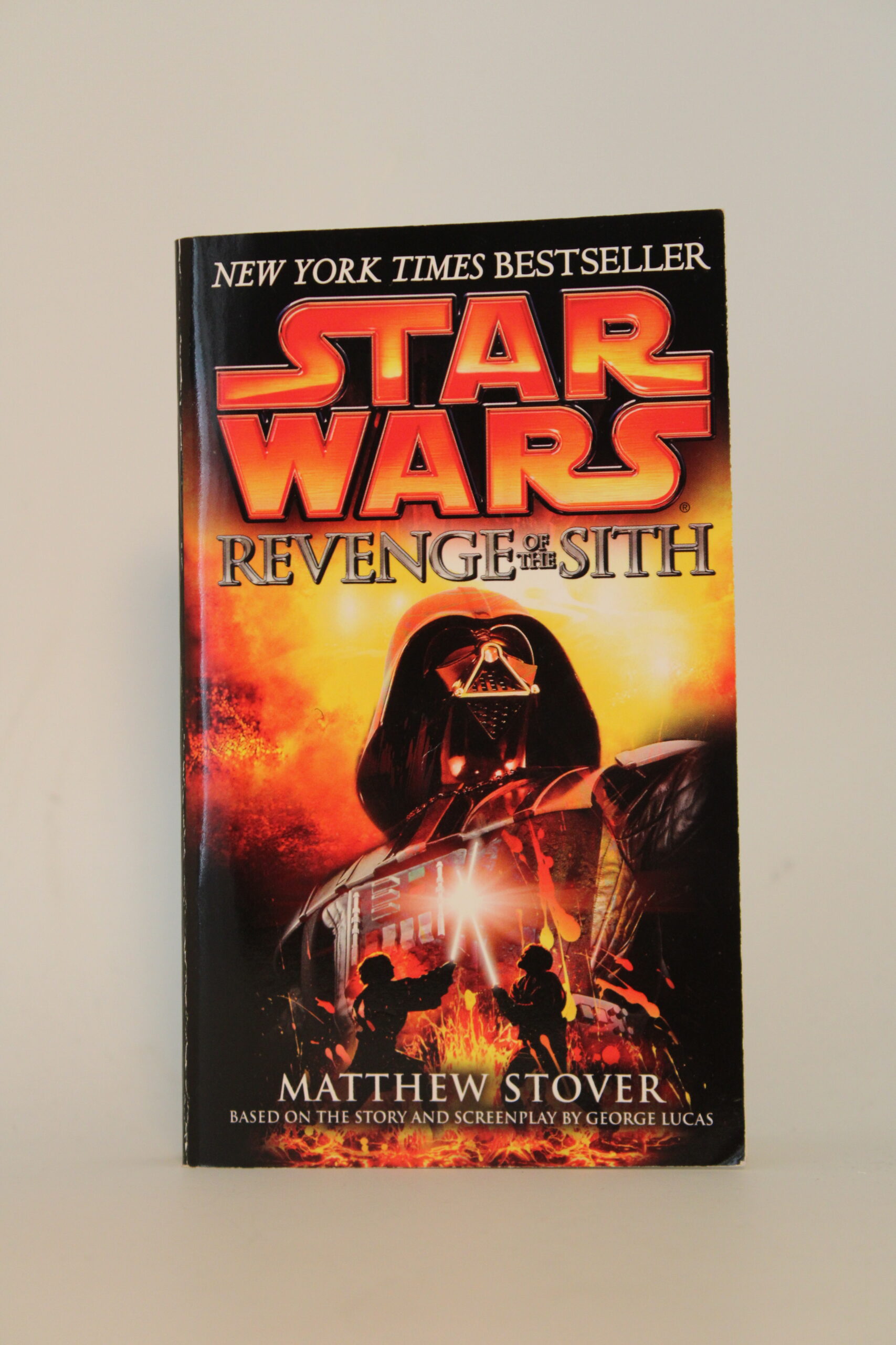 IMG_0631 An image of Star Wars: Revenge of the Sith with its front cover displaying a giant Darth Vader standing over a lightsaber duel of Anakin Skywalker and Obi-Wan Kenobi